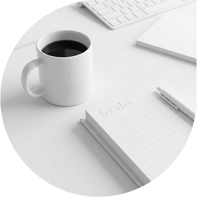 To-do list next to a cup of coffee and a work station