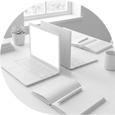 Two laptops back to back on a desk implying that two people are working together